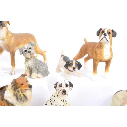 314 - A large collection of twenty unboxed dog study figurines by 'The Leonardo Collection' and others. To... 