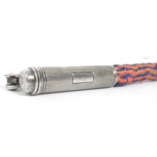 321 - A 1920's Flamidor Ouragan rope lighter. The lighter having engine turned decoration with blank carto... 