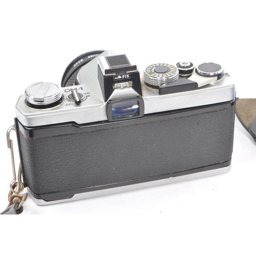 328 - A 20th century circa 1970s Olympus OM-1 MD 35mm SLR camera and lenses. The camera having a metal bod... 