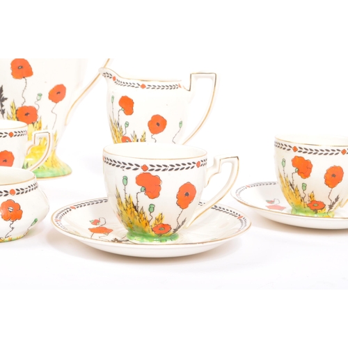 33 - A 1930S Art Deco hand painted 'Poppy' Pattern tea set by Crown Ducal. To comprise six cups, five sau... 