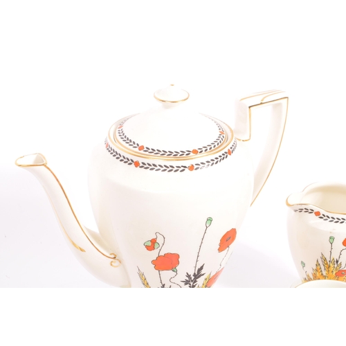 33 - A 1930S Art Deco hand painted 'Poppy' Pattern tea set by Crown Ducal. To comprise six cups, five sau... 