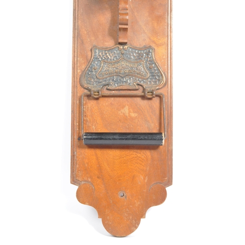 333 - Arts and Crafts style early 20th century toilet roll holder. Copper effect plaque with 