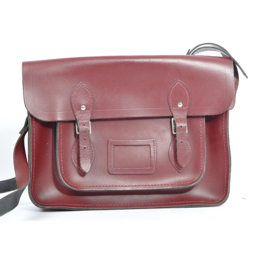 352 - A cherry red leather satchel by The Cambridge Satchel Company. With red stitching, shoulder strap an... 