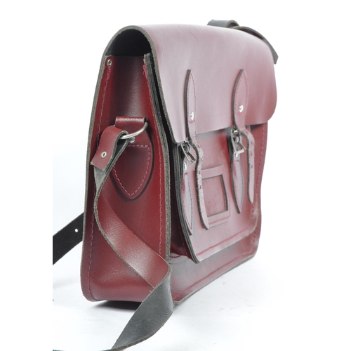 352 - A cherry red leather satchel by The Cambridge Satchel Company. With red stitching, shoulder strap an... 