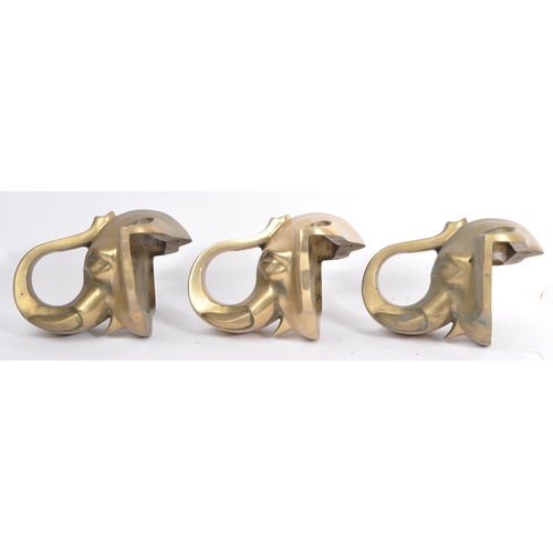 354 - A collection of three brass elephant head bar rail holder brackets. Each bracket being in the form o... 