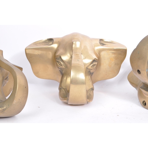 354 - A collection of three brass elephant head bar rail holder brackets. Each bracket being in the form o... 