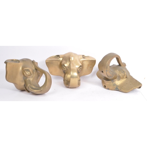 354 - A collection of three brass elephant head bar rail holder brackets. Each bracket being in the form o... 