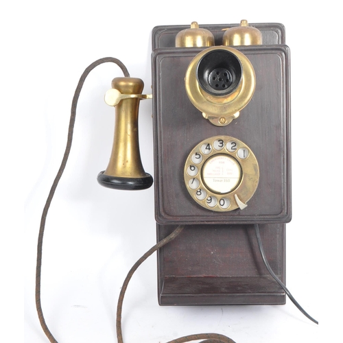 356 - An early 20th century circa 1930s wall hanging telephone. The telephone having a mahogany wooden cas... 