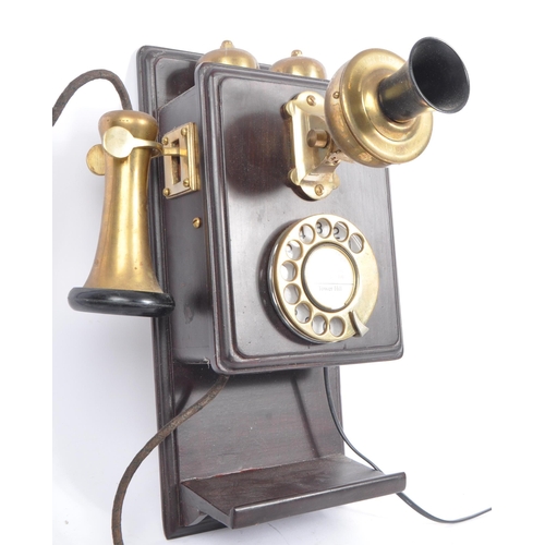 356 - An early 20th century circa 1930s wall hanging telephone. The telephone having a mahogany wooden cas... 