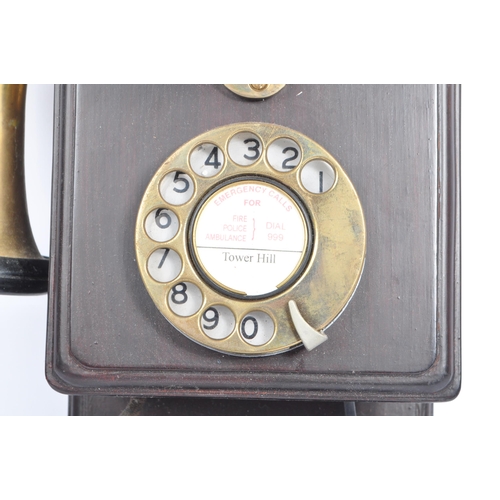 356 - An early 20th century circa 1930s wall hanging telephone. The telephone having a mahogany wooden cas... 