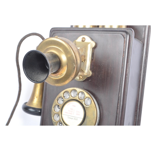 356 - An early 20th century circa 1930s wall hanging telephone. The telephone having a mahogany wooden cas... 