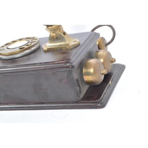 356 - An early 20th century circa 1930s wall hanging telephone. The telephone having a mahogany wooden cas... 