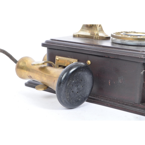 356 - An early 20th century circa 1930s wall hanging telephone. The telephone having a mahogany wooden cas... 