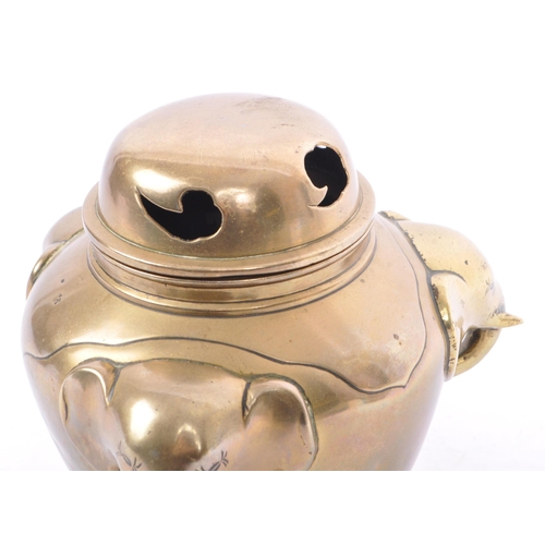 369 - An early 20th century brass elephant head censor pot. The censor having a bulbous brass body with pr... 