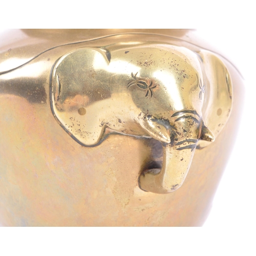 369 - An early 20th century brass elephant head censor pot. The censor having a bulbous brass body with pr... 