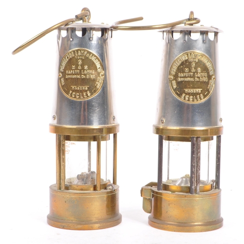 384 - A pair of 20th century brass and metal miners lamps. Manufactured by The Protector Lamp & lighting C... 