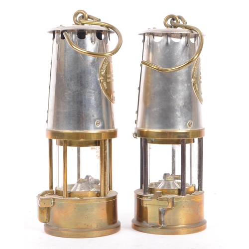 384 - A pair of 20th century brass and metal miners lamps. Manufactured by The Protector Lamp & lighting C... 