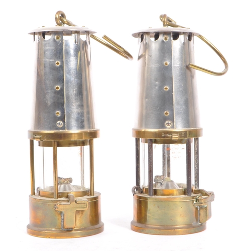 384 - A pair of 20th century brass and metal miners lamps. Manufactured by The Protector Lamp & lighting C... 