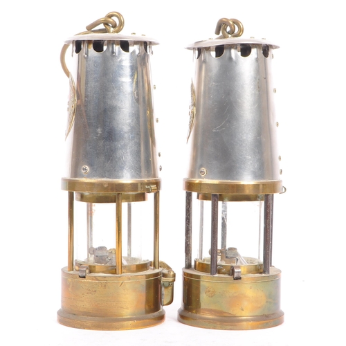 384 - A pair of 20th century brass and metal miners lamps. Manufactured by The Protector Lamp & lighting C... 