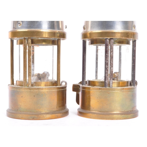 384 - A pair of 20th century brass and metal miners lamps. Manufactured by The Protector Lamp & lighting C... 