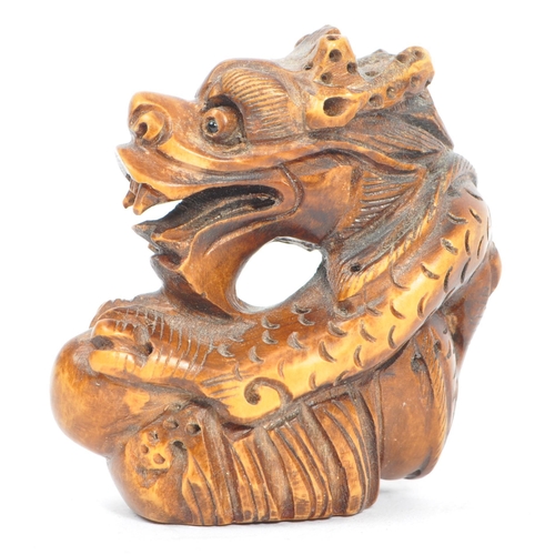 388 - A collection of three 19th century Japanese netsuke carved wooden figures. Comprising of mythical cr... 