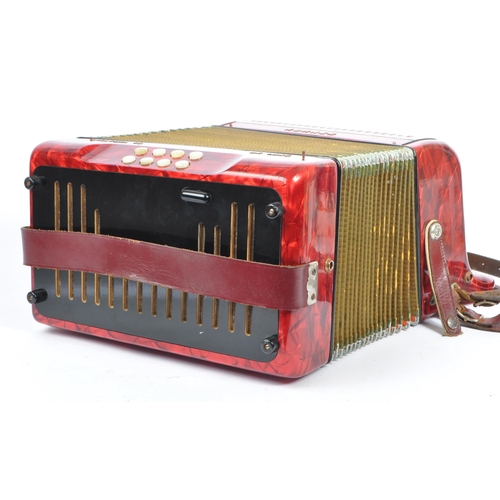 402 - Hohner - A German Hohner Amatona IV button musical instrument accordion DeLuxe. Having a red marble ... 