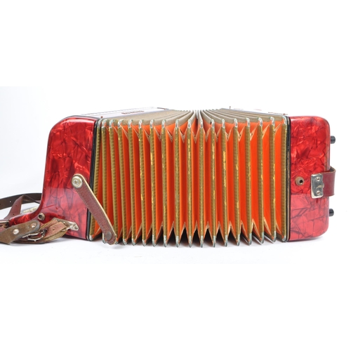 402 - Hohner - A German Hohner Amatona IV button musical instrument accordion DeLuxe. Having a red marble ... 