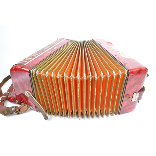 402 - Hohner - A German Hohner Amatona IV button musical instrument accordion DeLuxe. Having a red marble ... 