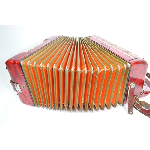 402 - Hohner - A German Hohner Amatona IV button musical instrument accordion DeLuxe. Having a red marble ... 