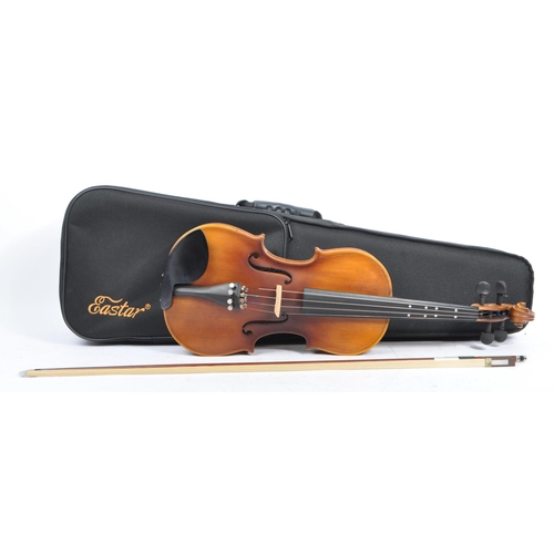 421 - A contemporary wooden acoustic Eastar violin. The violin being full sized, having a plastic chin res... 