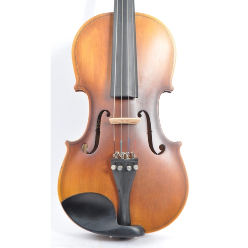 421 - A contemporary wooden acoustic Eastar violin. The violin being full sized, having a plastic chin res... 