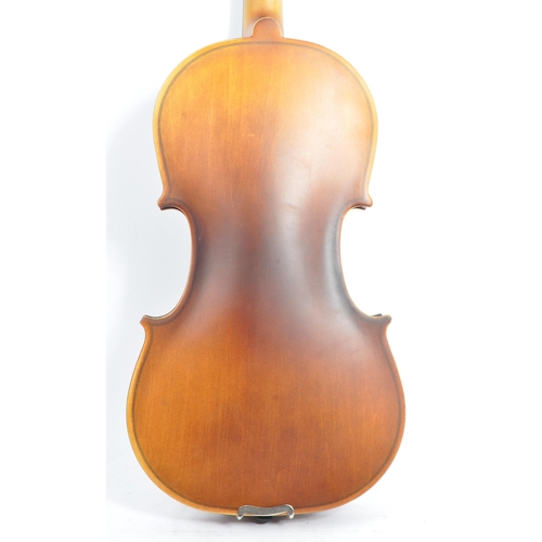 421 - A contemporary wooden acoustic Eastar violin. The violin being full sized, having a plastic chin res... 