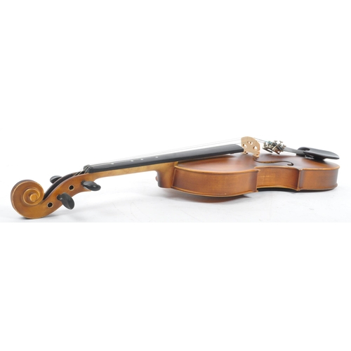 421 - A contemporary wooden acoustic Eastar violin. The violin being full sized, having a plastic chin res... 