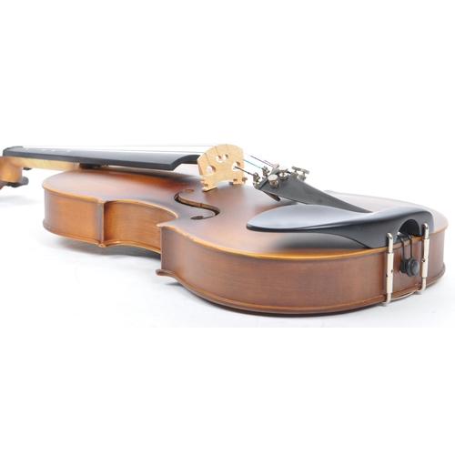 421 - A contemporary wooden acoustic Eastar violin. The violin being full sized, having a plastic chin res... 