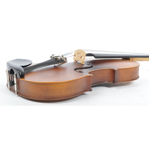 421 - A contemporary wooden acoustic Eastar violin. The violin being full sized, having a plastic chin res... 