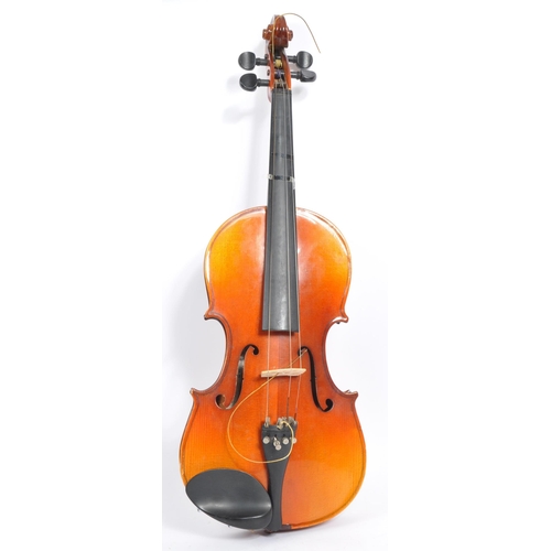 425 - A late 19th century circa 1890s violin, alongside another late 20th century example. The violin of w... 