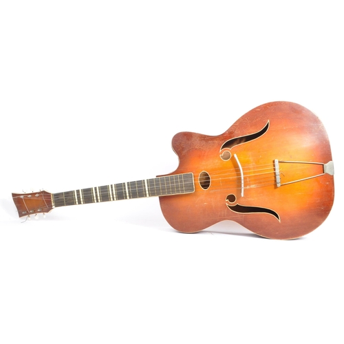 434 - A mid 20th century circa 1950s Melodija Rolyford archtop guitar. The guitar having a shaped hollow w... 