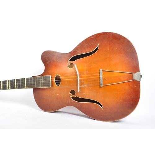 434 - A mid 20th century circa 1950s Melodija Rolyford archtop guitar. The guitar having a shaped hollow w... 