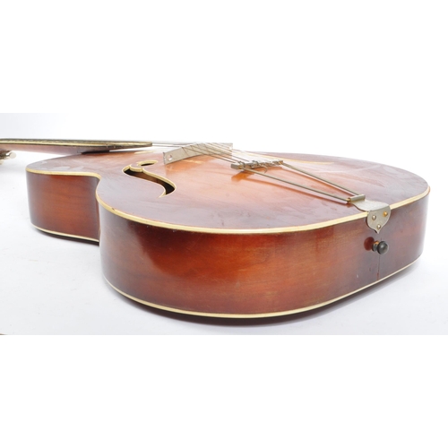 434 - A mid 20th century circa 1950s Melodija Rolyford archtop guitar. The guitar having a shaped hollow w... 