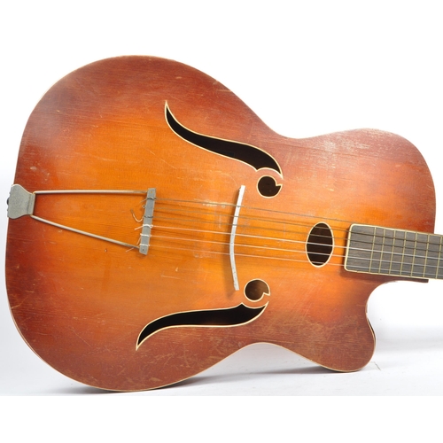 434 - A mid 20th century circa 1950s Melodija Rolyford archtop guitar. The guitar having a shaped hollow w... 