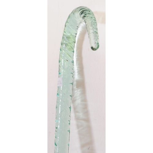 58 - A 19th century Nailsea glass walking stick. With curved handle and tapering body with textured surfa... 