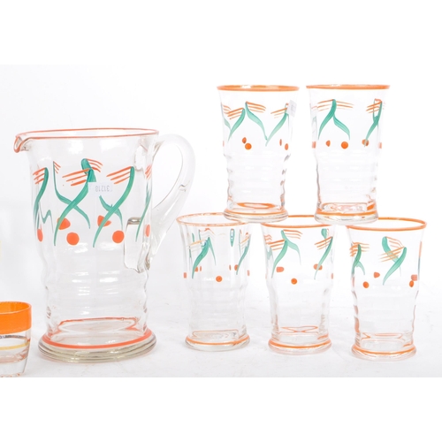 61 - A vintage mid 20th century lemonade set. With hand painted jug and with five drinking tumblers / gla... 