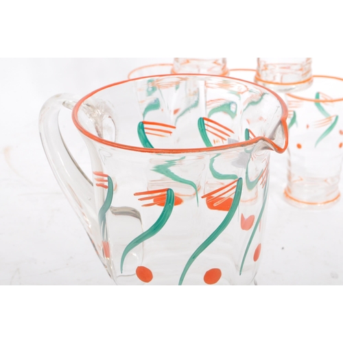 61 - A vintage mid 20th century lemonade set. With hand painted jug and with five drinking tumblers / gla... 