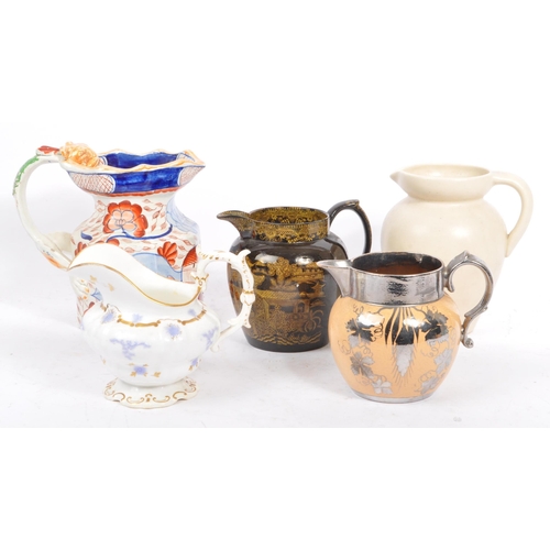 62 - A collection of five early 19th Century and later ceramic ware pottery jugs.With hand painted floral... 