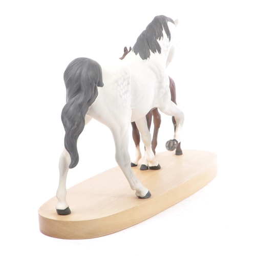 67 - Beswick - Spirit of Affection - A 20th century Beswick porcelain horse group figure modeled in the f... 