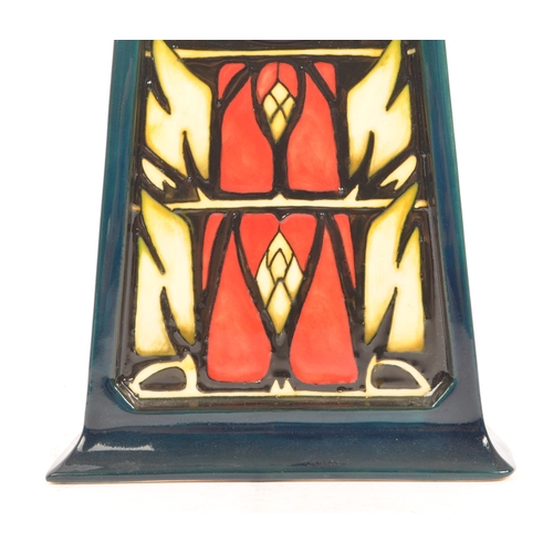 71 - Moorcroft Pottery - A contemporary Moorcroft ceramic mantel clock. With to point tapering body with ... 