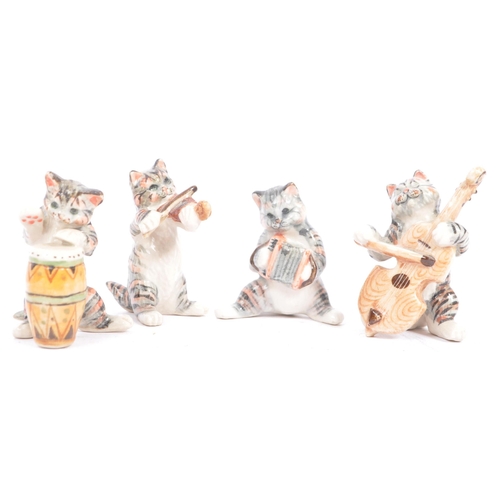 76 - Wade of England - A collection of 20th century porcelain cat figures. Including Wade of England Lady... 