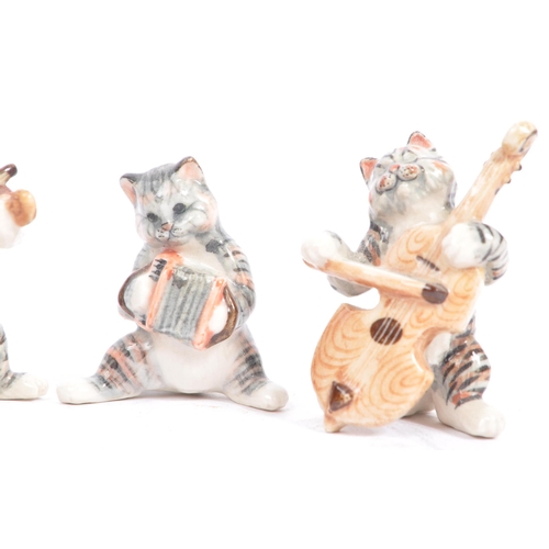 76 - Wade of England - A collection of 20th century porcelain cat figures. Including Wade of England Lady... 