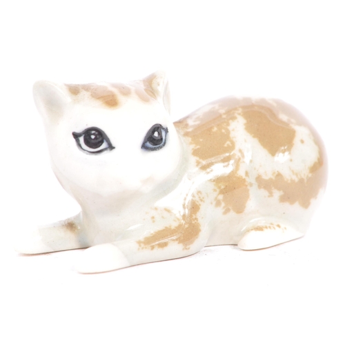 76 - Wade of England - A collection of 20th century porcelain cat figures. Including Wade of England Lady... 