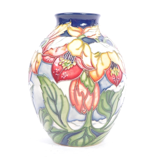 79 - Moorcroft Pottery - A contemporary 21st century ceramic hand painted Moorcroft vase. A 'Christmas He... 